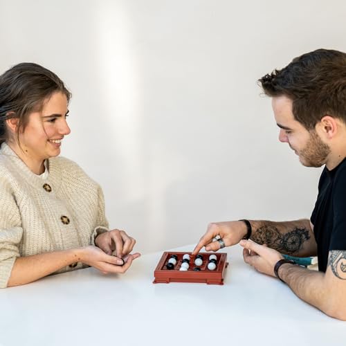WHAT DO YOU MEME? Orbito white marbles ready for strategic play and quick decisions.