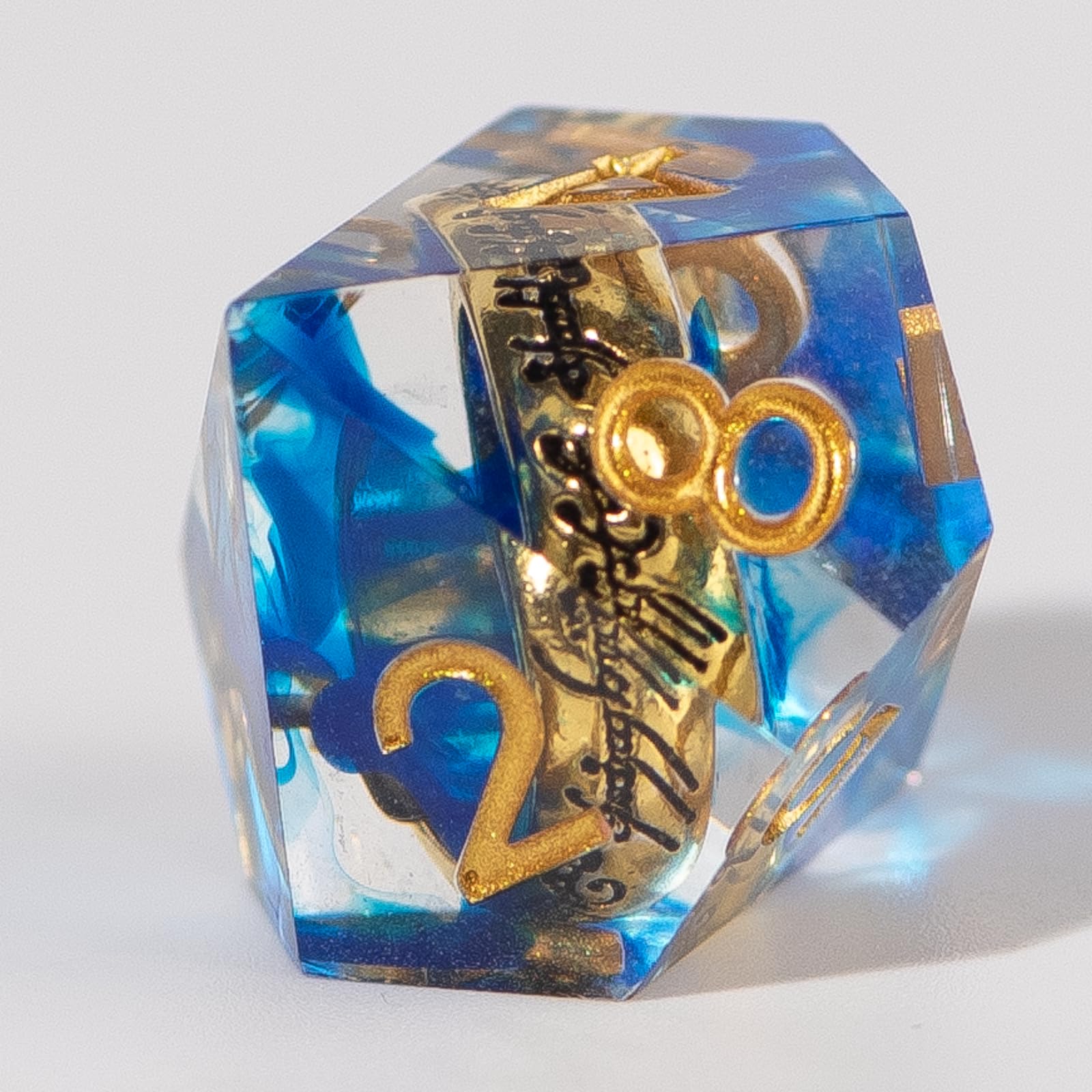 WizardsArcanum resin dice with readable ring inscriptions under light.