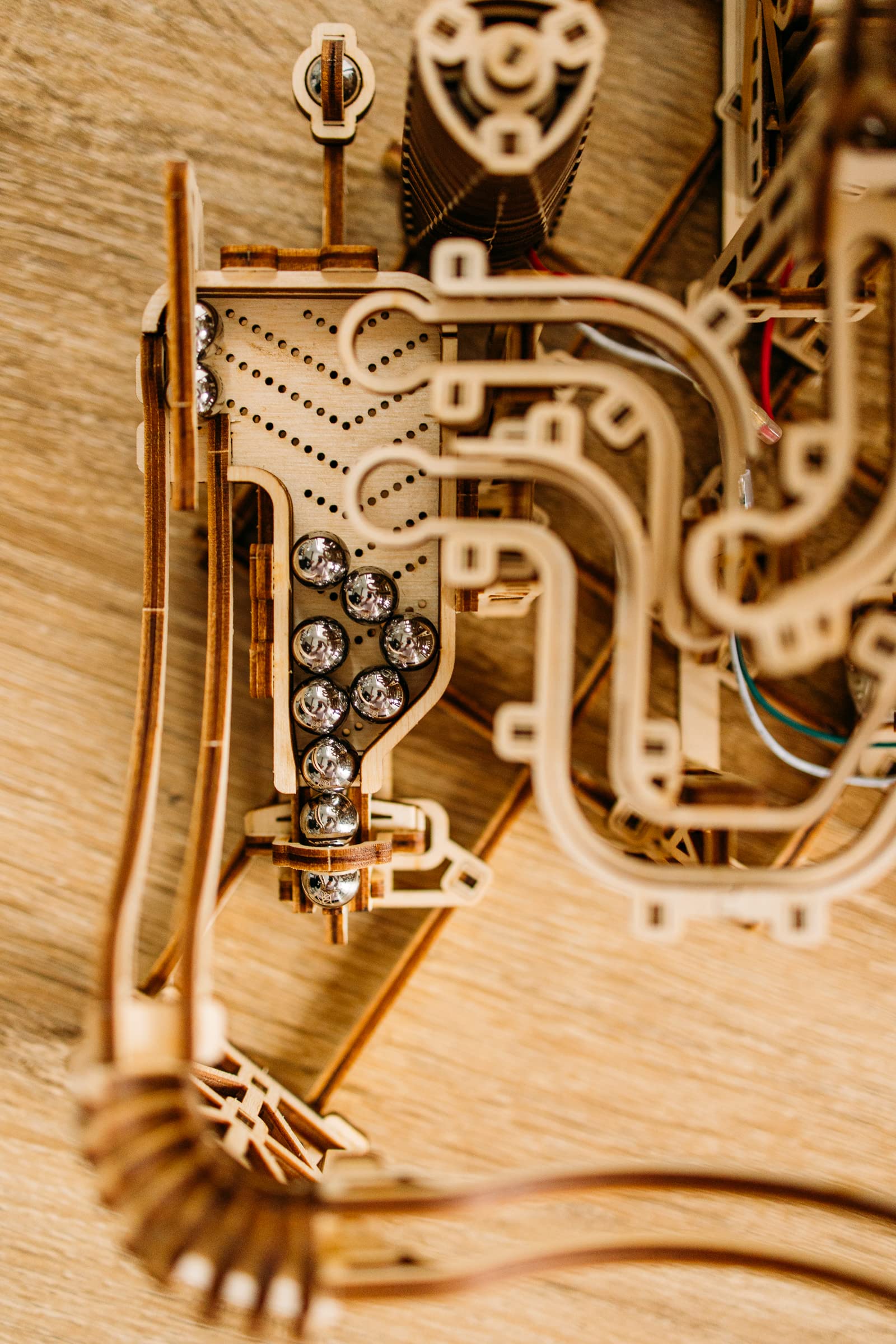 Wood Trick electric motor marble run enables continuous motion for interactive play.