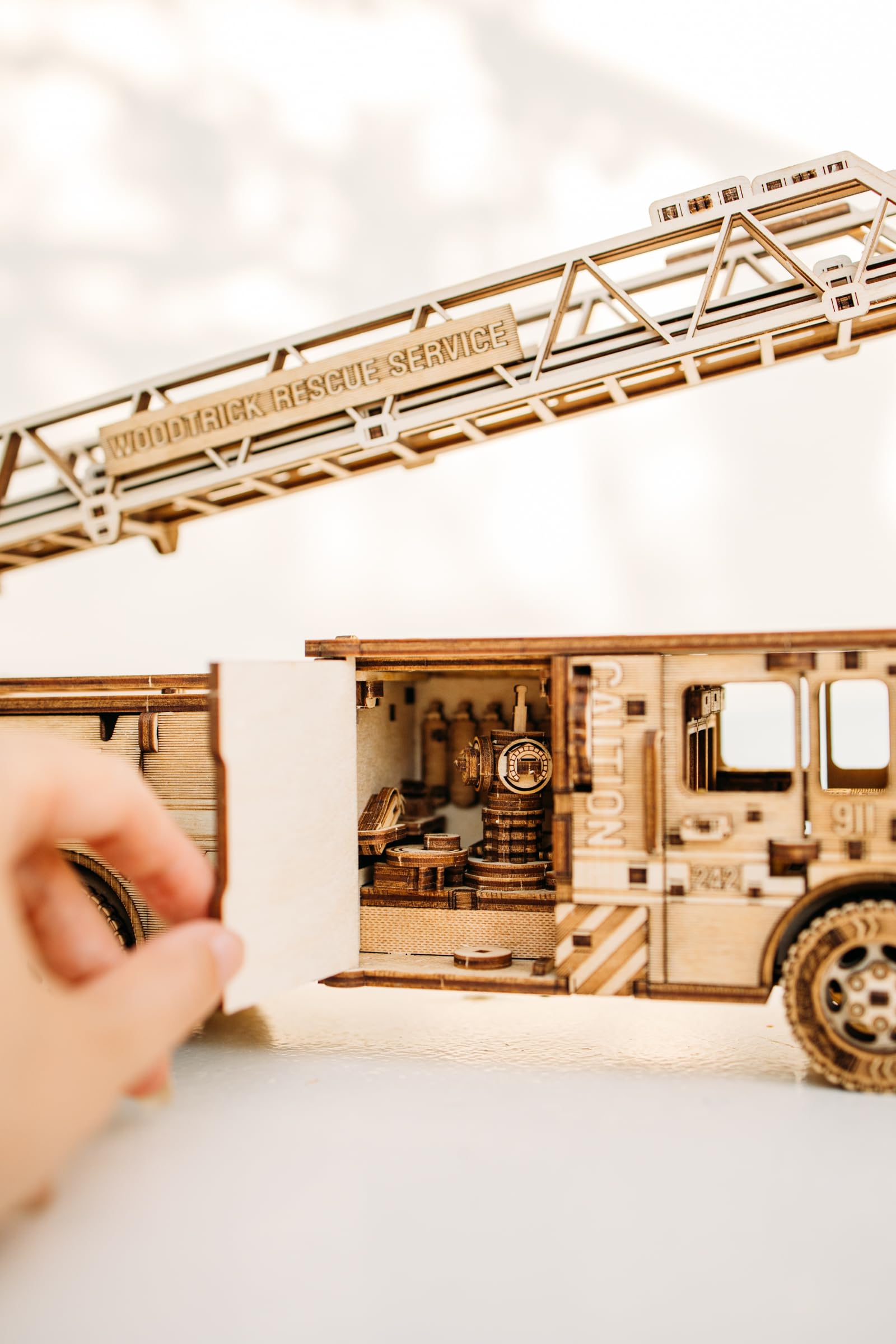Wood Trick Rescue Firetruck spring motor powers forward motion up to 20 feet.