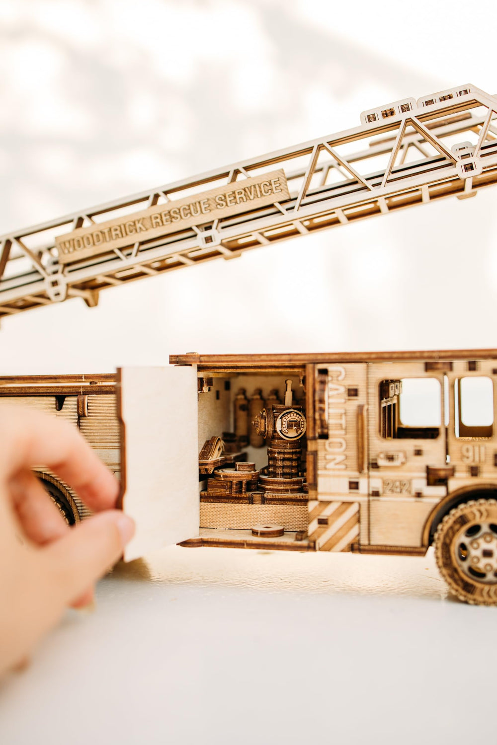 Wood Trick Rescue Firetruck spring motor powers forward motion up to 20 feet.