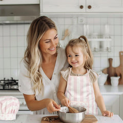 WoodenEdu pink kid apron supports imaginative cooking and crafts.