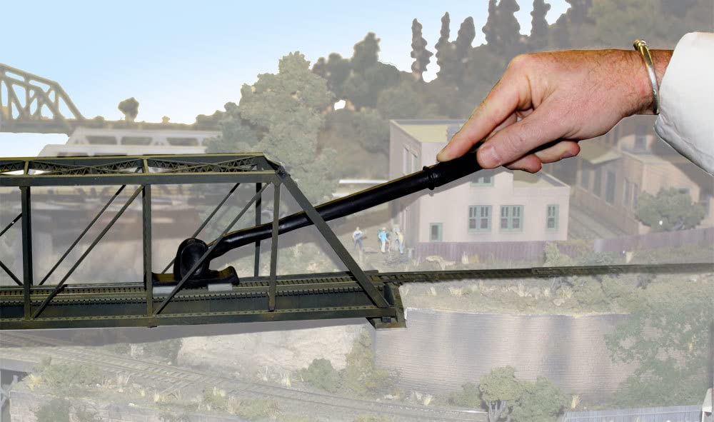 Woodland Scenics Tidy Track Rail Tracker Cleaning Kit brush-in-use demonstrates effective grime removal.