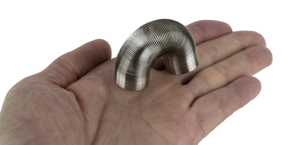 World's Smallest Slinky miniature close-up coil, ideal as a giftable desk accent.