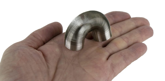 World's Smallest Slinky miniature close-up coil, ideal as a giftable desk accent.