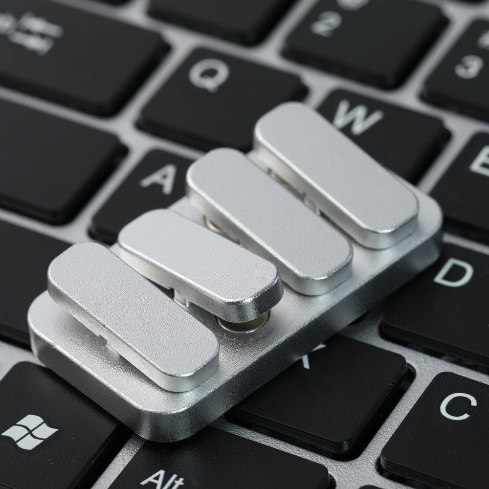 WSHWXY metal fidget slider on desk, a stylish office accessory for tactile play.