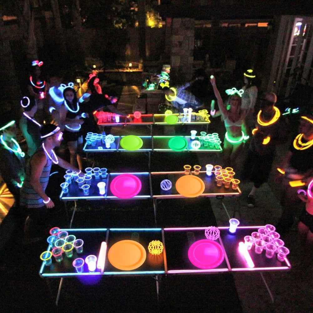 XJLANTTE neon party plates shown on a table with black light glow