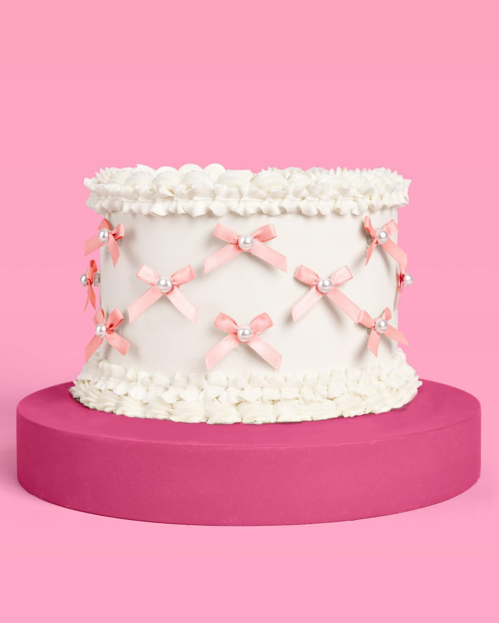 xo Fetti mini pink bows with pearls decorating a cake with style