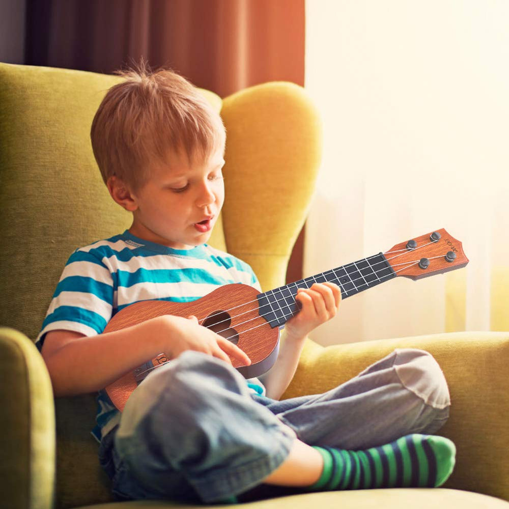 YEZI Kids ukulele brown hands strumming, builds early rhythm and coordination.