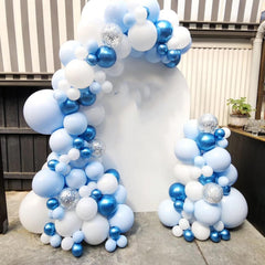 YMSZ baby shower decor featuring blue-white balloons and confetti.