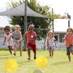 YNHFIFI kids playing outdoors with the playground ball for active fun.