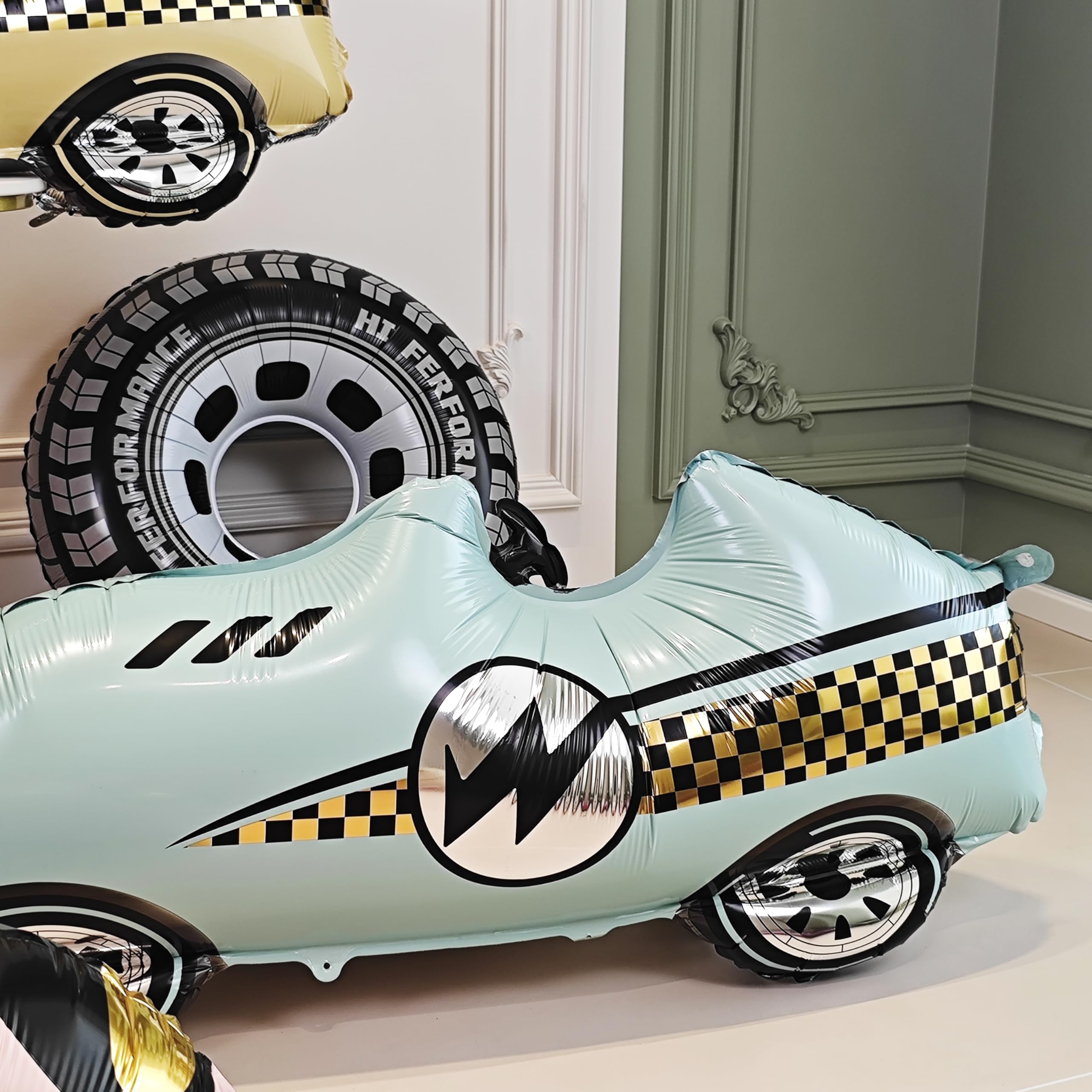 YOIOZAIZAI blue race car balloon as a photo backdrop.
