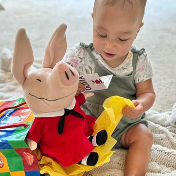 Removable dress feature on Olivia pig plush adds play value.