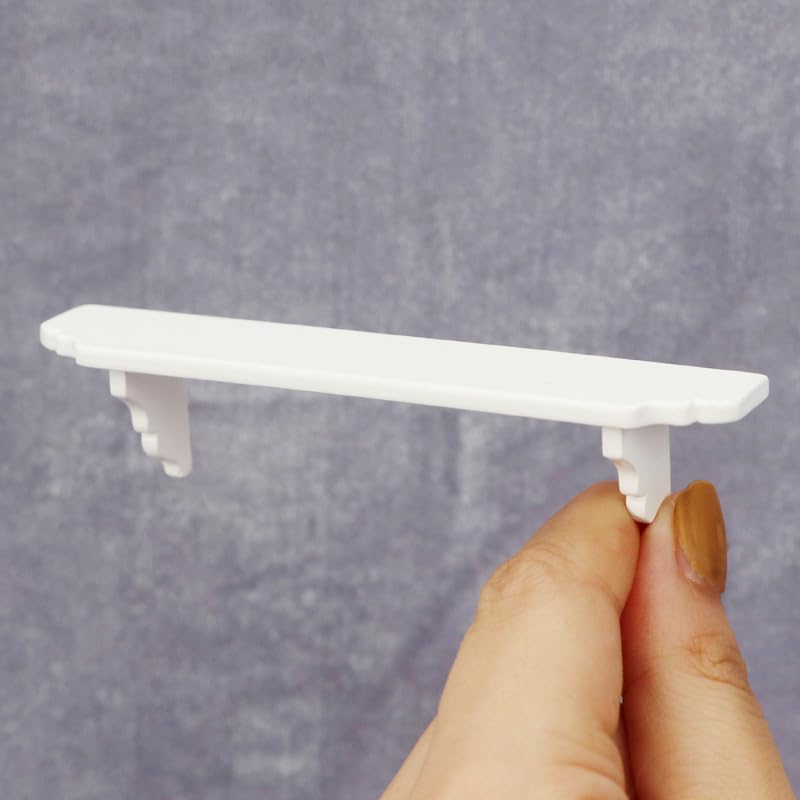 YuanHolumid white storage shelves for minis and accessories.