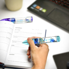 Red lava pen swirl supports sensory focus while drafting notes.