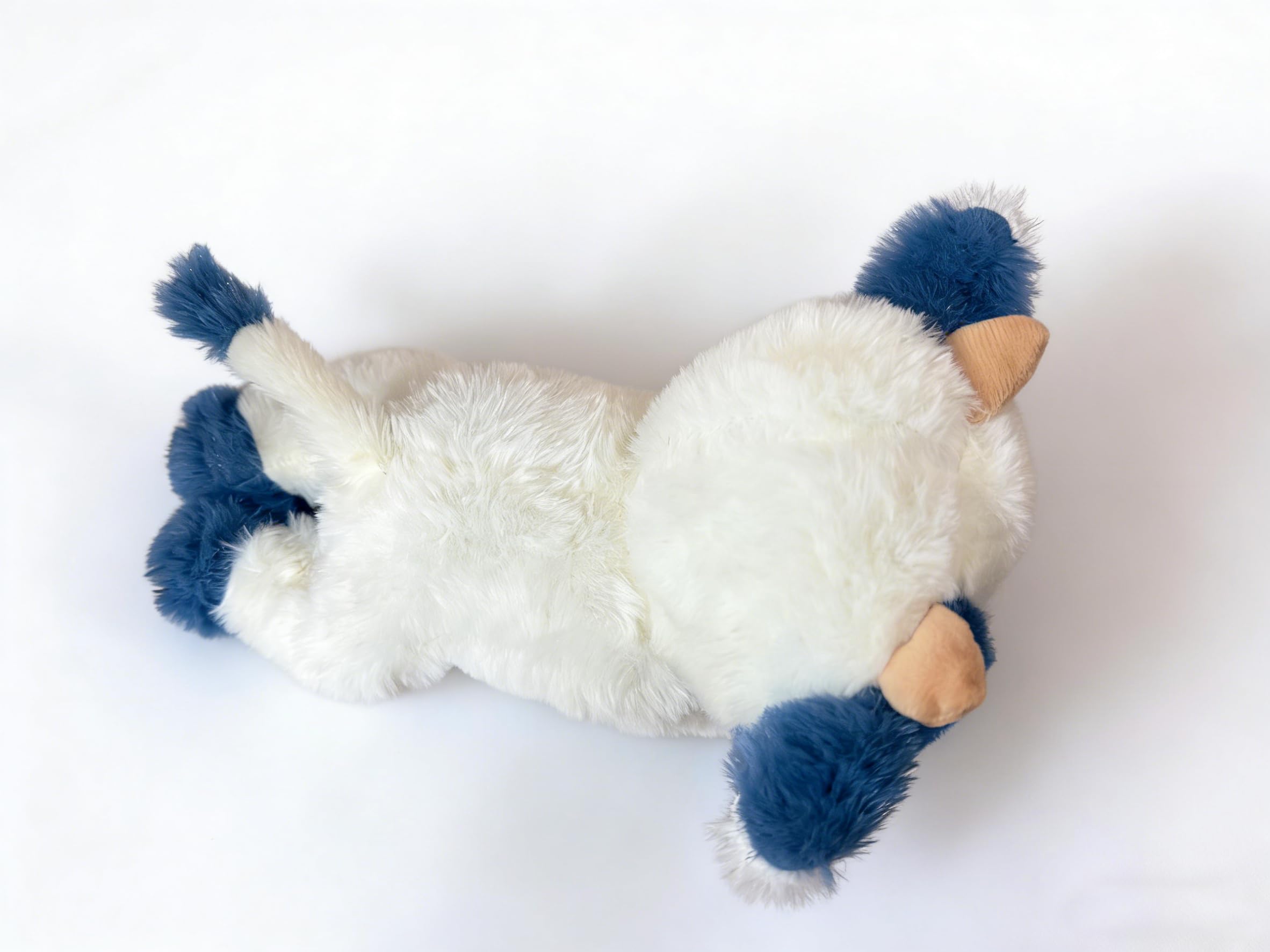 YUKOUQIAN cow plush in a living room for cozy relaxation