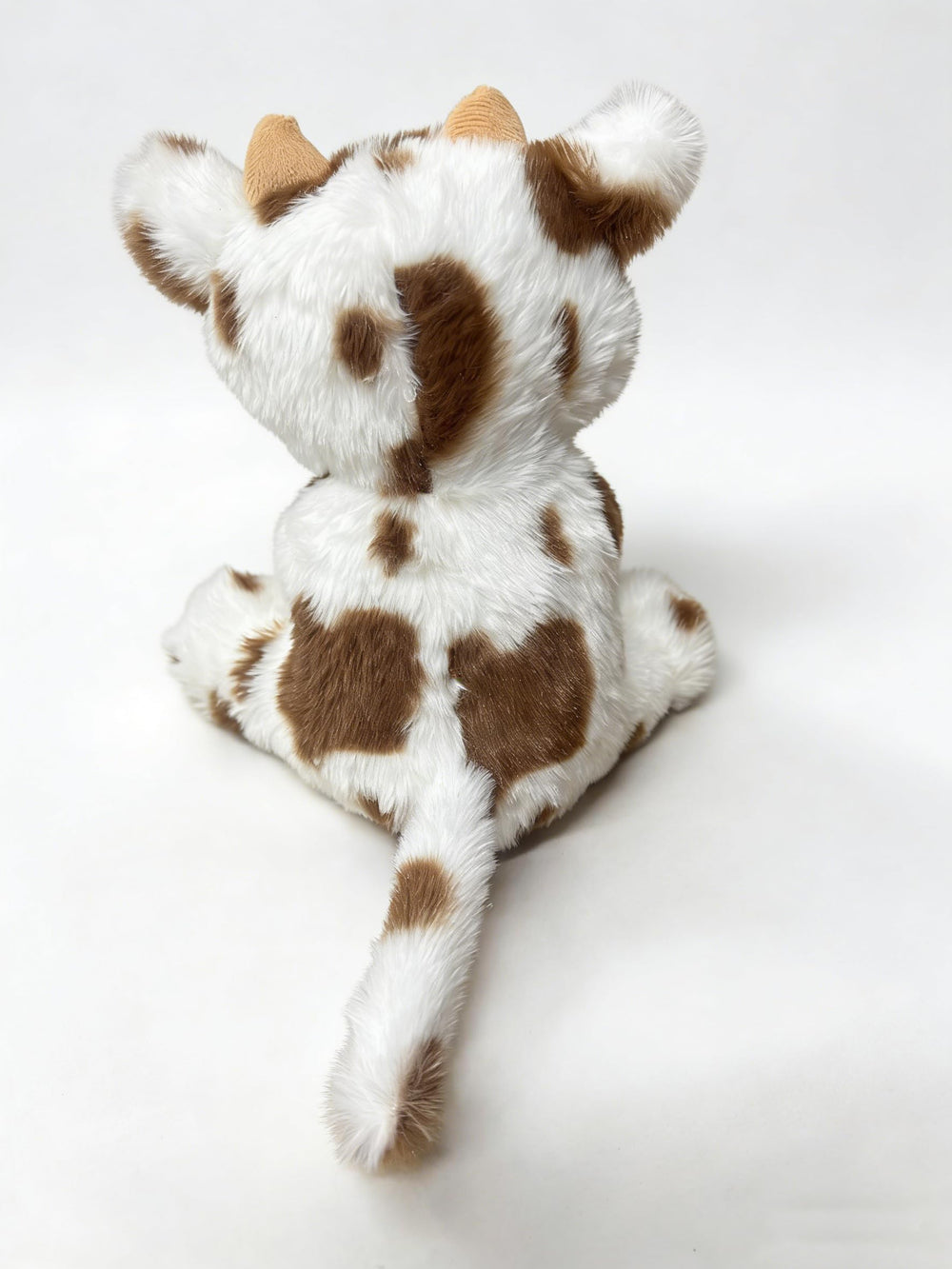 YUKOUQIAN cow plush on a sofa during a cozy movie night.