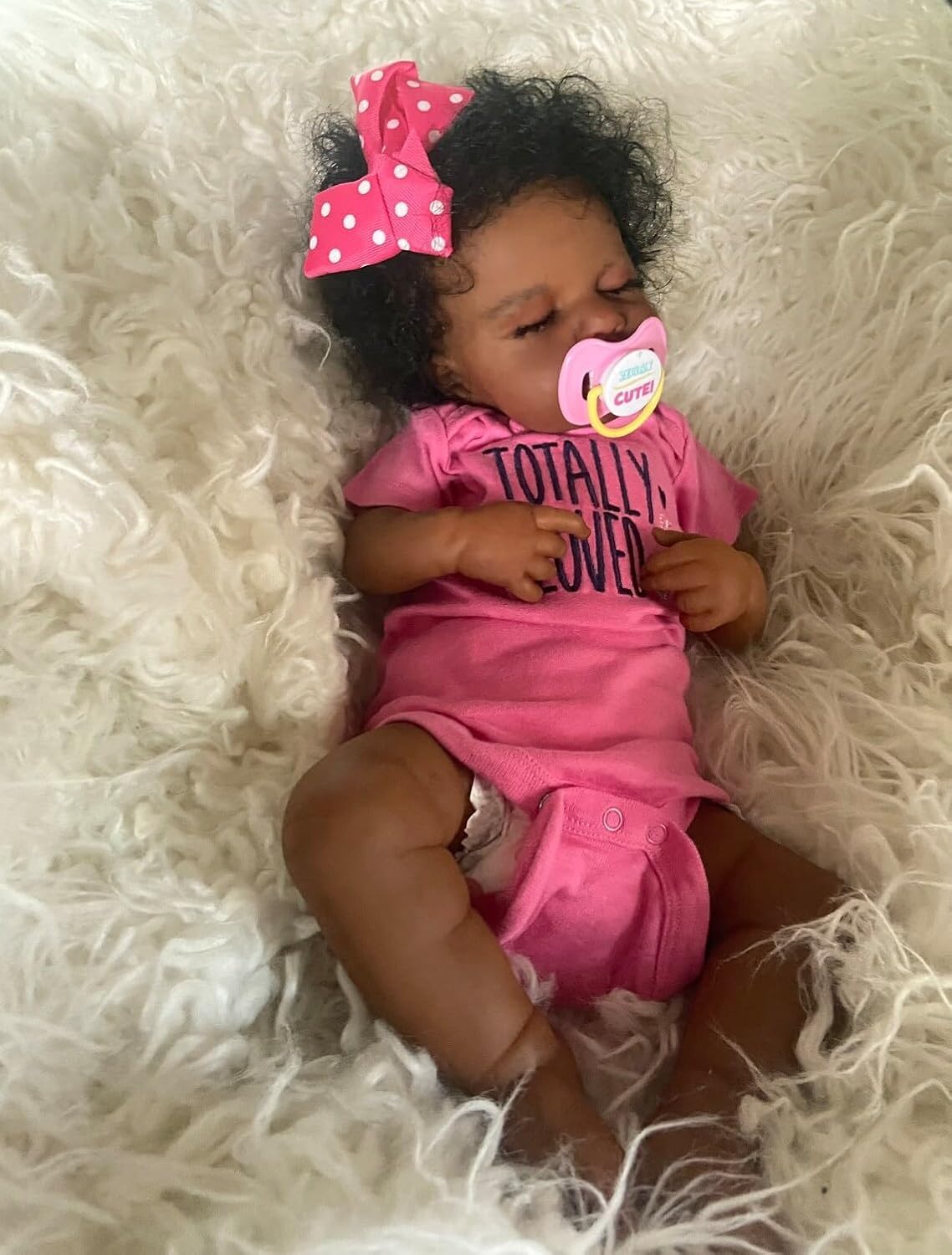 Zero Pam Black Reborn Doll with accessories: pacifier, bottle, birth certificate.