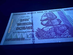 Zimbabwe 50 Trillion AA P90 note in protective sleeve, preserving pristine condition